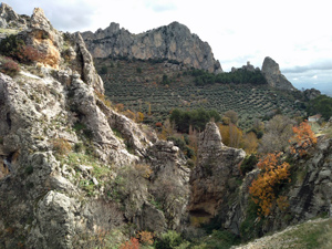 Castle on skyline (R) seen from road walk