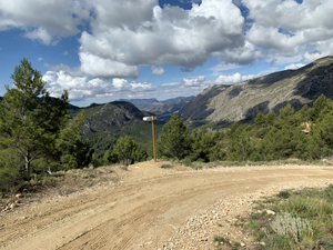Fingerpost on PR-CV9 marking left trail to casa with the solar p